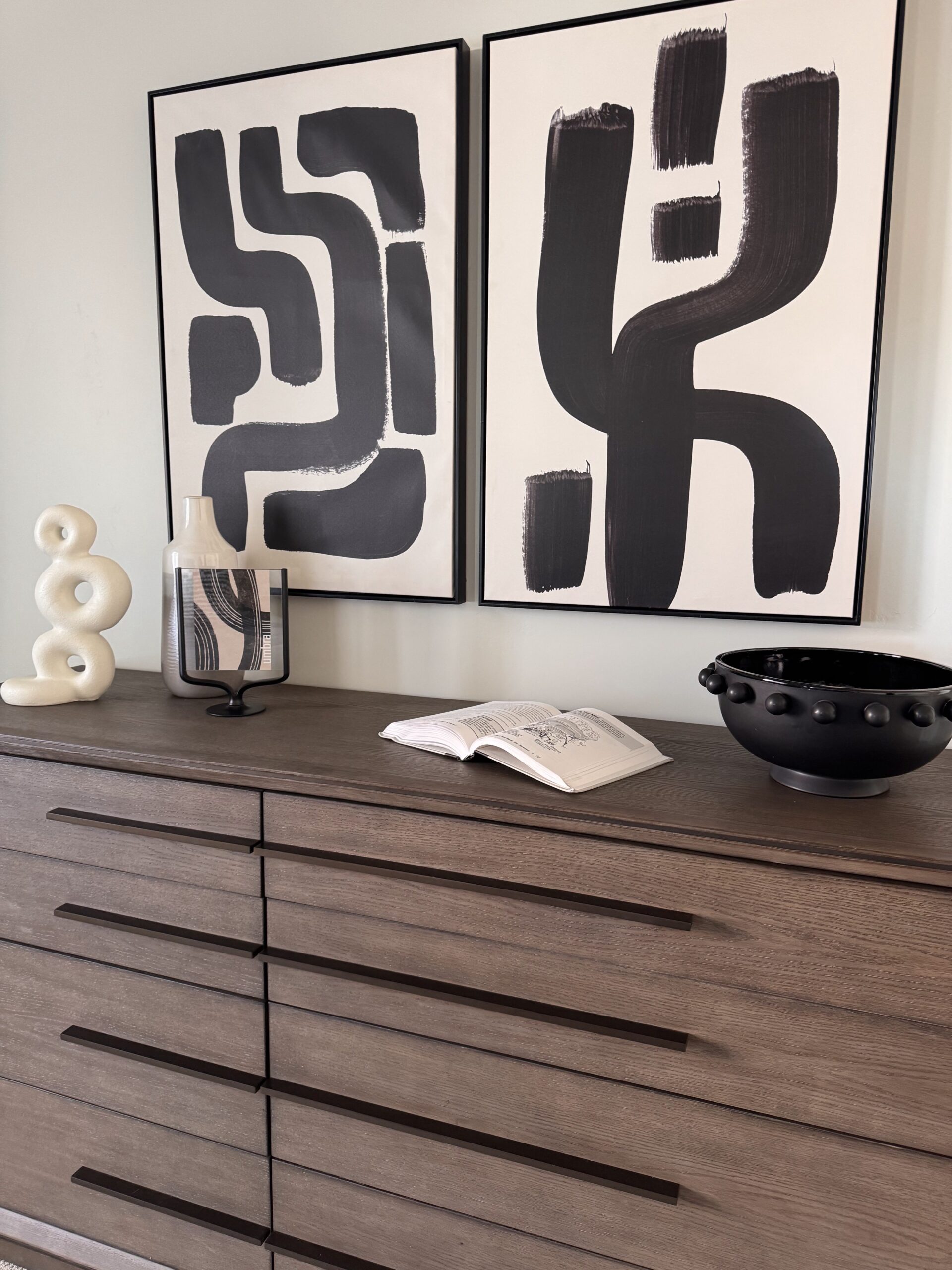 Professional home staging in Southern Utah showing styled bedroom dresser with modern artwork and neutral decor